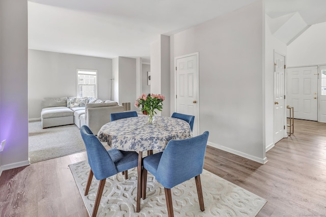 dining room with wood finished floors, visible vents, and baseboards