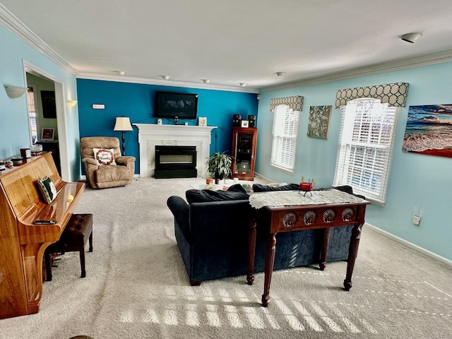 living room featuring carpet flooring, ornamental molding, baseboards, and a glass covered fireplace