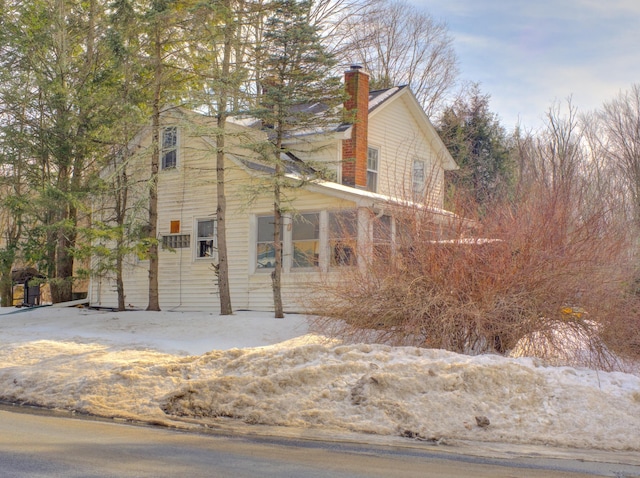 view of side of home featuring a chimney