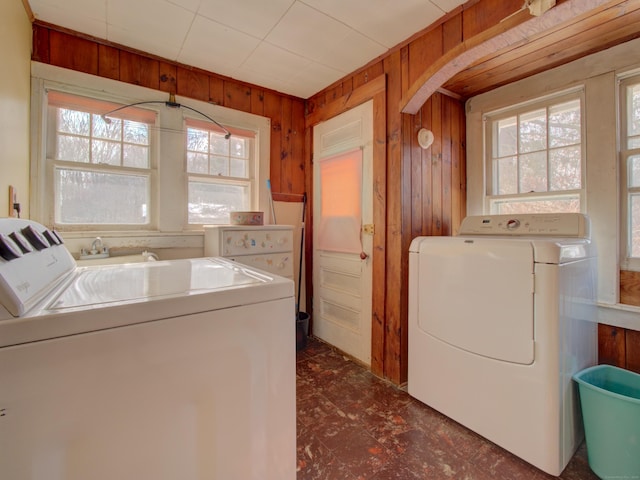 laundry area featuring laundry area, washing machine and dryer, and wooden walls