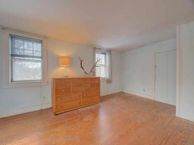 unfurnished bedroom with light wood-style flooring