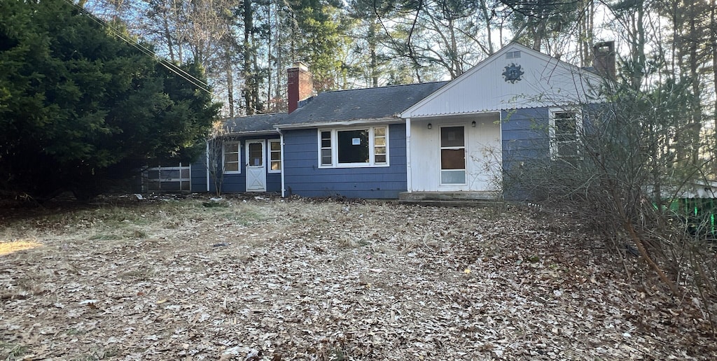 ranch-style home featuring a chimney