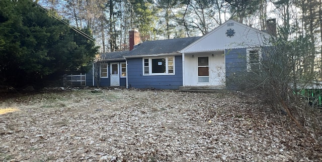 ranch-style home featuring a chimney