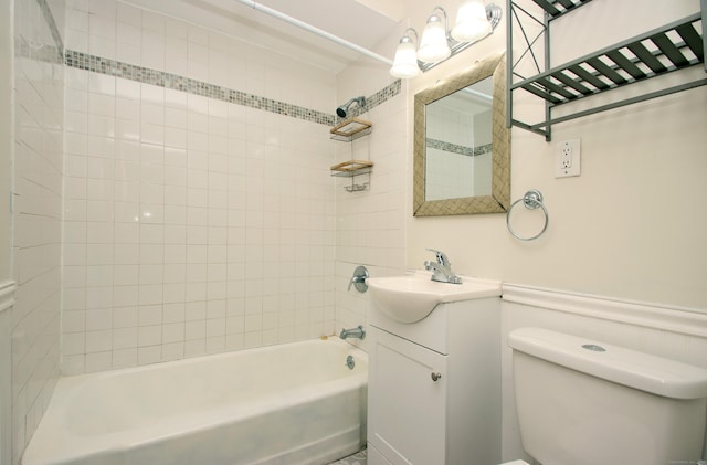 full bathroom featuring wainscoting, vanity, toilet, and bathing tub / shower combination