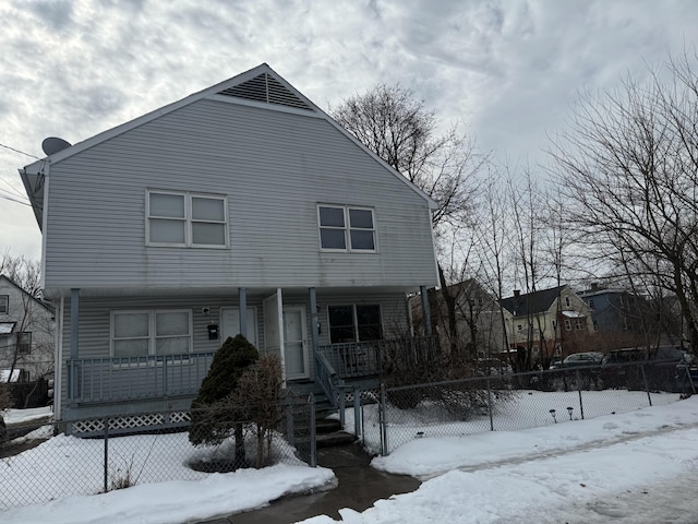 view of front of property featuring a porch and fence