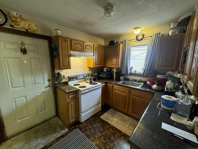 kitchen with brown cabinets, white electric stove, dark countertops, a sink, and under cabinet range hood