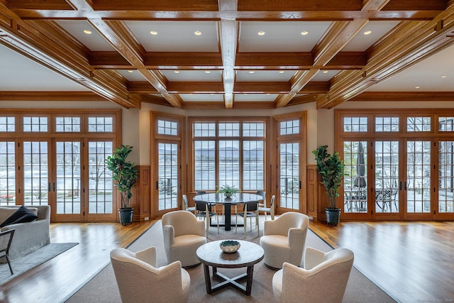 living room featuring french doors, beamed ceiling, and coffered ceiling