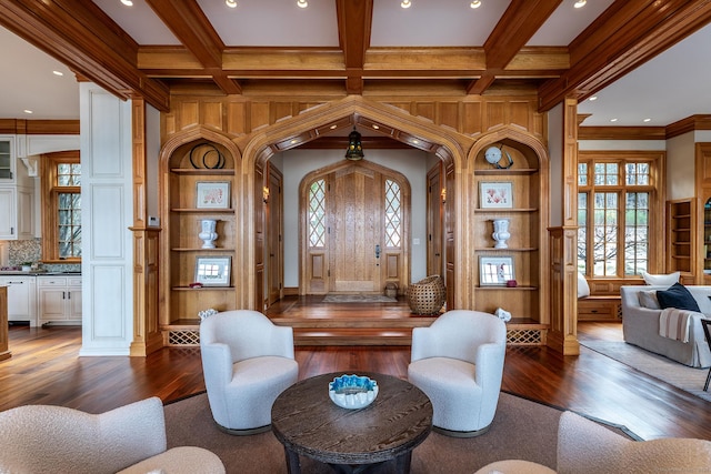 living area featuring dark wood-type flooring, coffered ceiling, and beamed ceiling