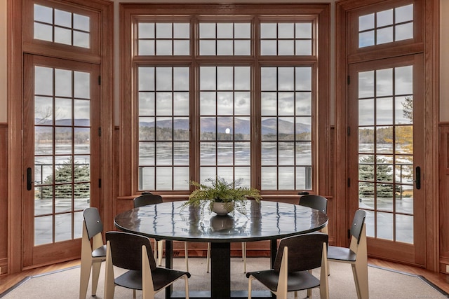 dining area with a mountain view and light wood-style flooring