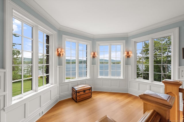 sunroom / solarium featuring a water view