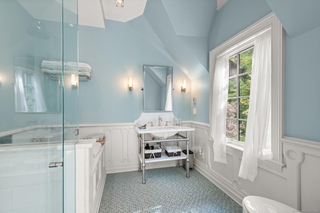 full bathroom with lofted ceiling, wainscoting, a shower stall, and vanity