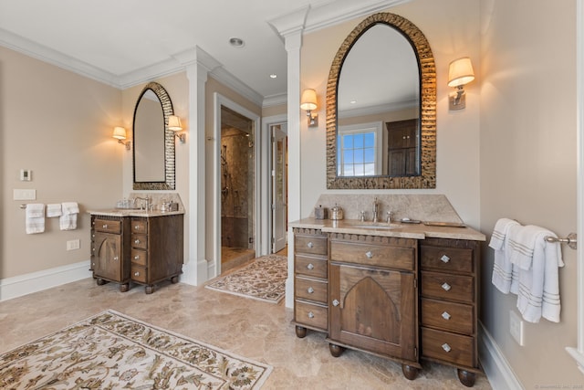 bathroom with a sink, crown molding, ornate columns, a shower stall, and two vanities