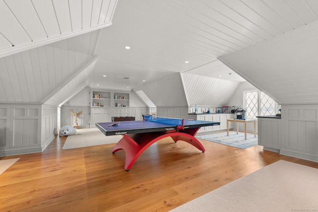 rec room with recessed lighting, a decorative wall, vaulted ceiling, wood finished floors, and wooden ceiling