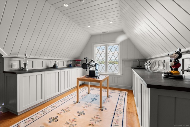 office space with light wood-type flooring and vaulted ceiling