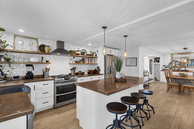 11 Pearl St, Groton, CT 06340 - kitchen featuring stainless steel appliances, wall chimney exhaust hood, light wood-style floors, and open shelves