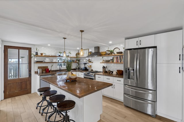 11 Pearl St, Groton, CT 06340 - kitchen with open shelves, light wood-type flooring, appliances with stainless steel finishes, and a sink