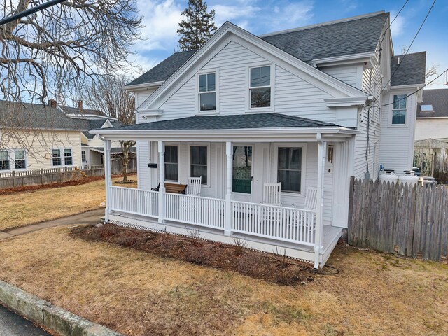 11 Pearl St, Groton, CT 06340 - view of front of property with fence, covered porch, a front lawn, and a shingled roof