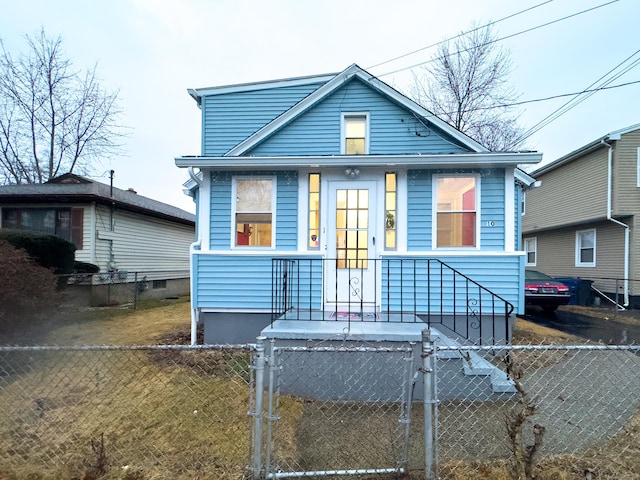 bungalow-style home featuring a fenced front yard and a gate