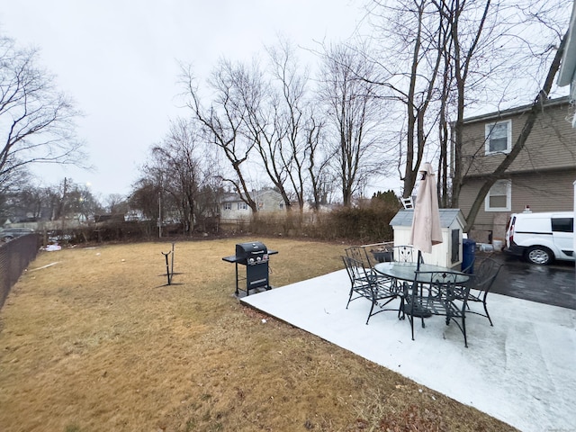 exterior space with an outbuilding, fence, and area for grilling