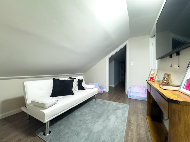 sitting room featuring vaulted ceiling, dark wood finished floors, and baseboards