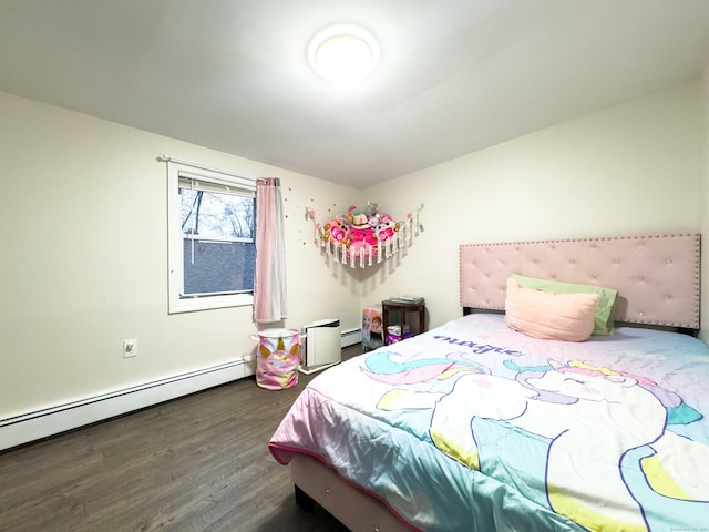 bedroom with baseboard heating and wood finished floors