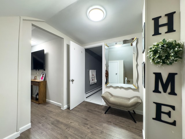 hall featuring a baseboard radiator, lofted ceiling, baseboards, and wood finished floors