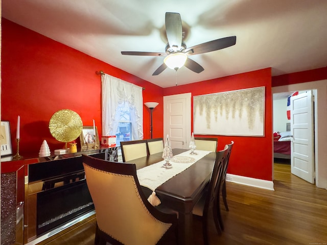 dining room featuring ceiling fan, baseboards, and wood finished floors