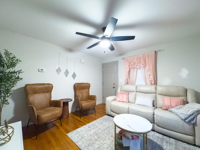 living room featuring a ceiling fan and wood finished floors