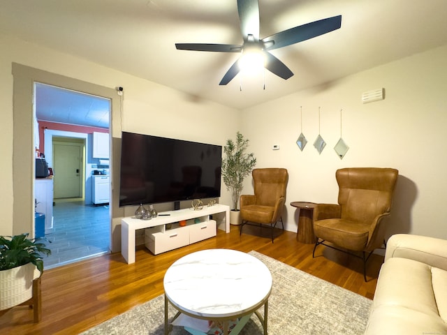 living room featuring ceiling fan and wood finished floors