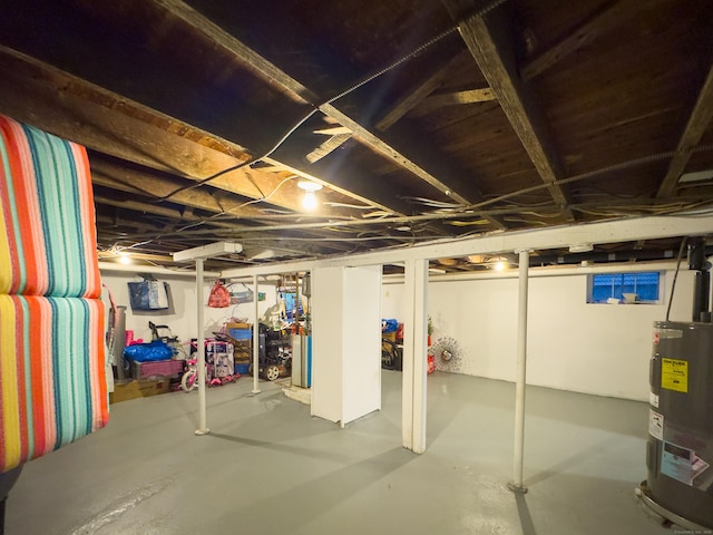 unfinished basement featuring water heater