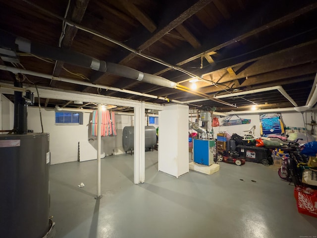 unfinished basement featuring heating fuel and electric water heater