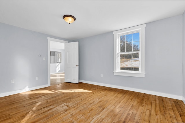 unfurnished room featuring light wood finished floors and baseboards