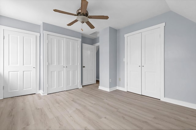 unfurnished bedroom featuring multiple closets, ceiling fan, light wood-style flooring, and baseboards