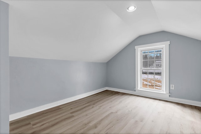 bonus room featuring light wood-type flooring, recessed lighting, baseboards, and lofted ceiling