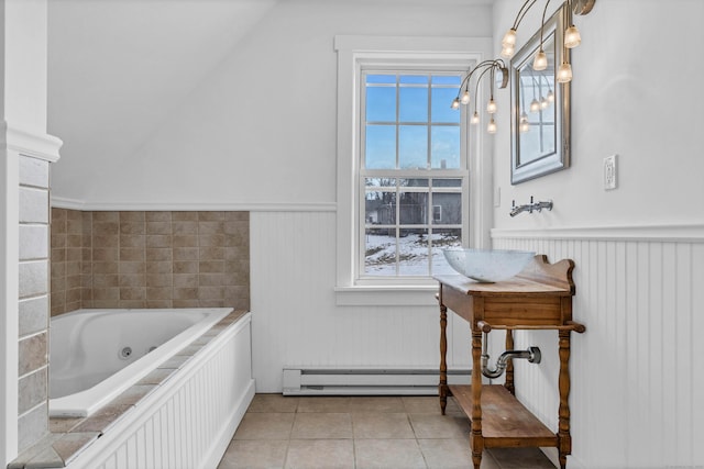 full bath featuring a baseboard radiator, a wainscoted wall, tile patterned flooring, and plenty of natural light