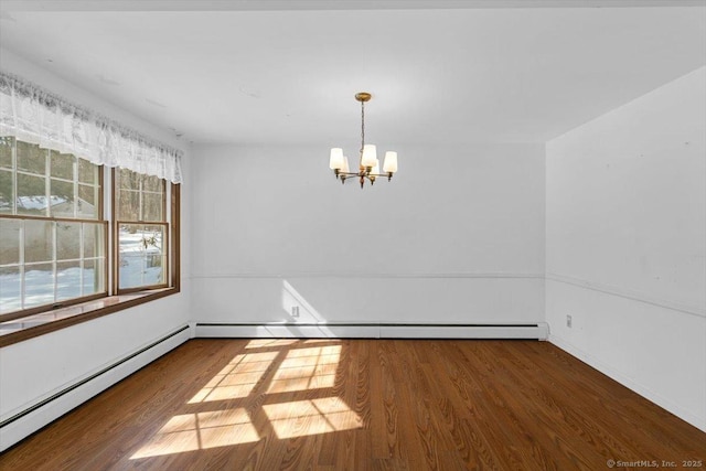 spare room with a baseboard heating unit, baseboard heating, an inviting chandelier, and wood finished floors