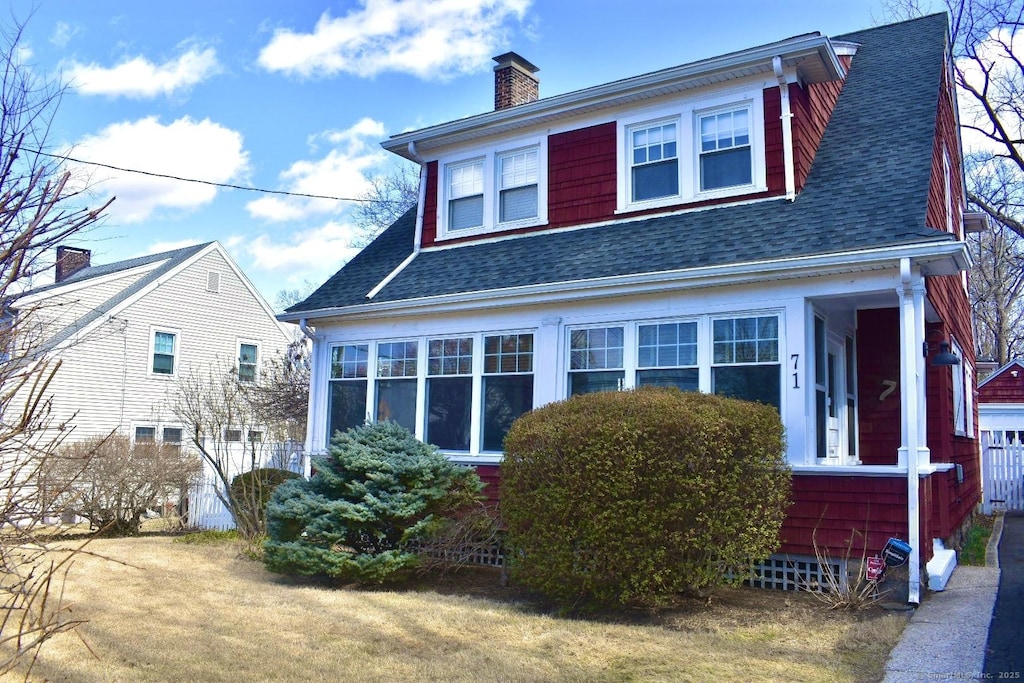 view of home's exterior with a shingled roof and a chimney