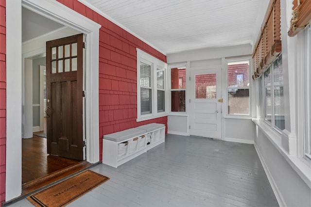 mudroom featuring crown molding, wood finished floors, and baseboards