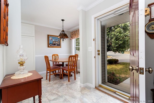 dining space featuring baseboards and ornamental molding