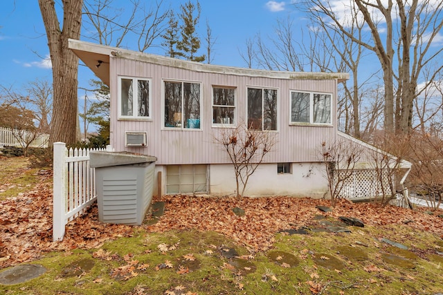 view of side of home featuring fence