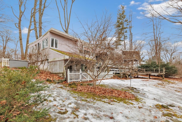 snow covered property featuring fence