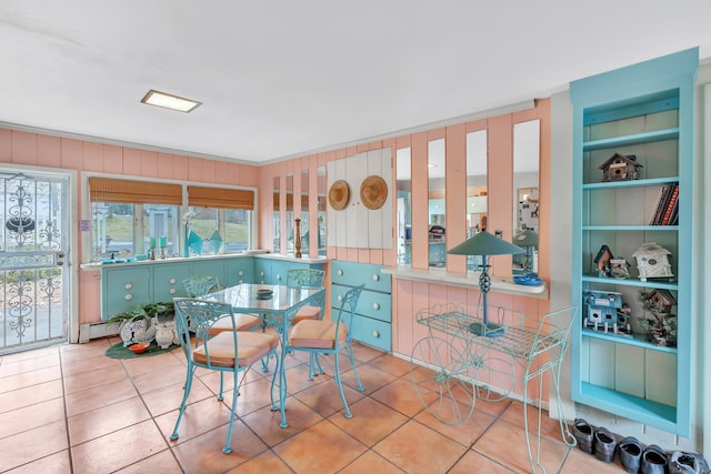 dining room with built in shelves and tile patterned floors