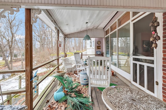 sunroom with vaulted ceiling and plenty of natural light