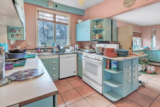 kitchen with light tile patterned floors, open shelves, light countertops, a sink, and white appliances