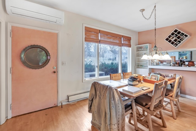 dining room featuring light wood finished floors, a wall mounted AC, and baseboard heating