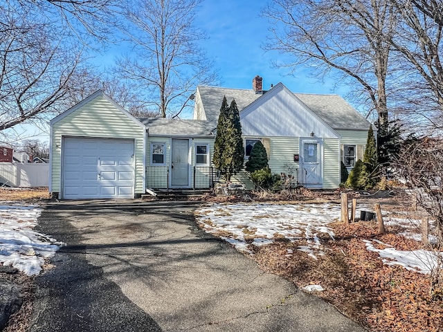 view of front of home featuring an attached garage, driveway, a chimney, and roof with shingles