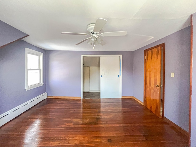 unfurnished bedroom with baseboards, a ceiling fan, wood finished floors, a baseboard heating unit, and a closet