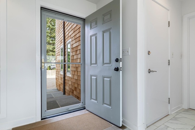 entrance foyer featuring marble finish floor