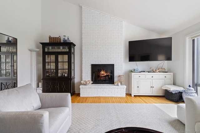 4 Old Fenwick Rd, Old Saybrook, CT 06475 - living area featuring lofted ceiling, light wood-type flooring, and a fireplace