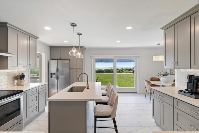 4 Old Fenwick Rd, Old Saybrook, CT 06475 - kitchen featuring gray cabinets, appliances with stainless steel finishes, light marble finish flooring, recessed lighting, and a breakfast bar area